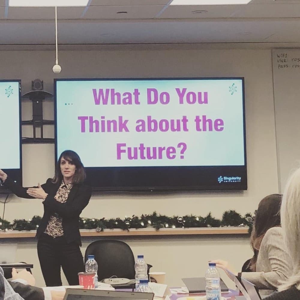 Sura presenting a slide that asks “What do you think about the future?”